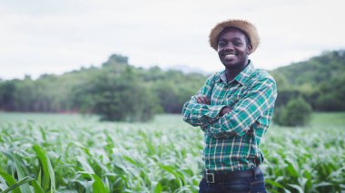Afrikalı çiftçi gülümseme ve mutlulukla organik çiftlikte duruyor. Tarım ya da tarım kavramı