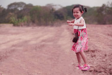 Portrait of happy dancing and  smiling little child girl
