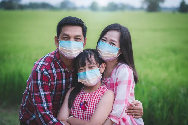 Power of family fighting covid-19 concept.Father mother and daughter wearing face mask for protect corona virus with smile and happy