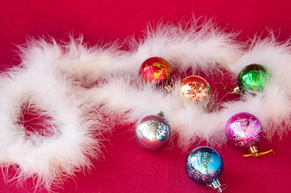 Christmas card: Christmas balls and Swan\'s down on red fabric