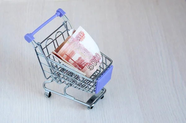 Iron trolley for food with Russian rubles on the table