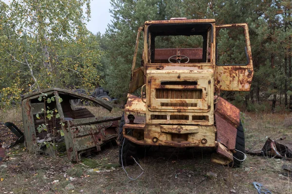 Old abandoned bulldozer, radioactive vehicle near ghost town Pripyat, post apocalyptic city, spring season in Chernobyl exclusion zone, Ukraine