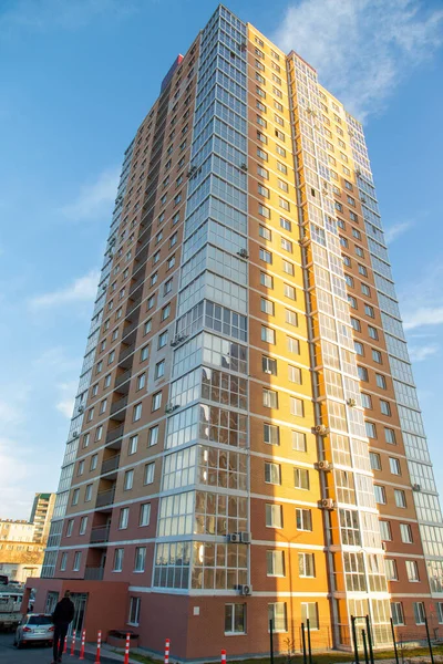 Gökyüzüne karşı modern çok katlı tuğla ve cam bina. Kahverengi, bej. İnşaat.