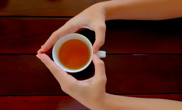 cup of tea in hand, top view