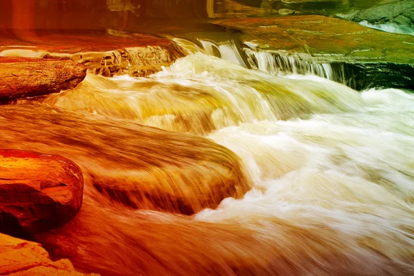 Multicolor stroom van de waterval over de steen in de rivier — Stockfoto