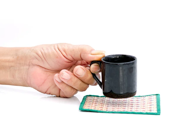 Hand hold with black cup on the white table — Stock Photo, Image