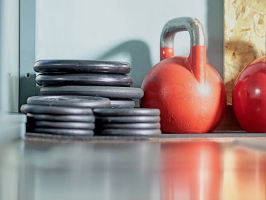 Kulplu demir top, spor salonunda halter ağırlığı.