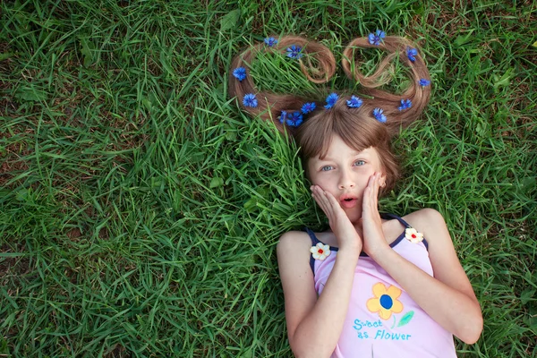 Surprised girl with cornflowers in her hair — Stock Photo, Image