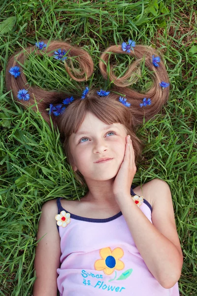 Girl with cornflowers in her hair looking above — Stock Photo, Image