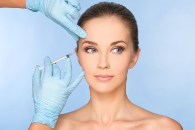 Beauty woman giving botox injections. clipart