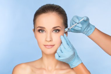 Beauty woman giving botox injections. clipart