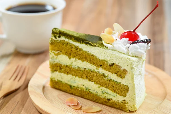 Green tea cake with a coffee cup — Stock Photo, Image