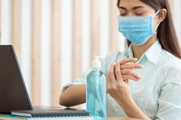 Asian woman wearing protective mask and using alcohol antiseptic gel clean wash hand sanitizer anti virus bacteria dirty skin care coronavirus