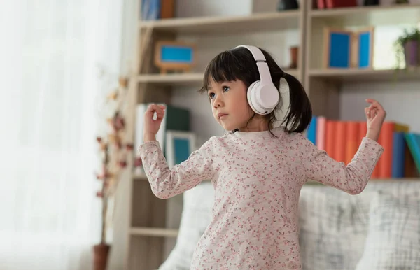 Heureux Enfant Asiatique Amuser Écouter Musique Avec Les Écouteurs Danser Image En Vente