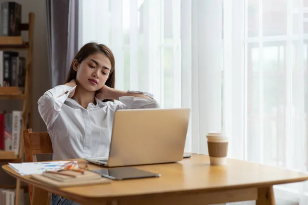 Young asian business woman with pain in neck in office