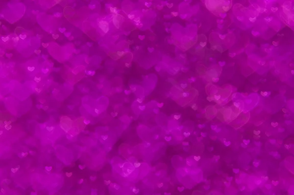 Světlé pozadí rozostření abstraktní purpurová srdce — Stock fotografie