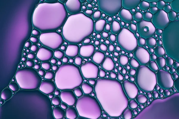 Purple drops of oil and air bubbles on the water — Stock Photo, Image