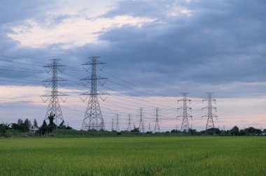 Yüksek voltajlı elektrik direği yapısı ya da günbatımında yüksek voltajlı elektrik iletim kulesi