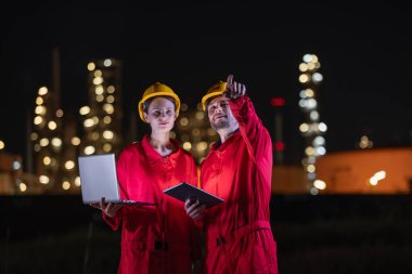 Gece vardiyasında, petrol ve gaz rafinerisinde çalışan mühendisler gece yarısı petrol endüstrisinde çalışan işçiler. Petrol ve Gaz Petrokimya endüstrisi.