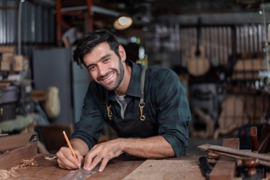Luthier, el aletleri, sanat ve el sanatları konseptiyle çalışma odasında geleneksel aletleri kullanarak gitarın tepesini yapıyor..