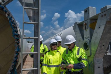Rüzgâr türbini bakım ve onarım teknisyeni, mühendis türbinleri kontrol ediyor. Rüzgar türbini çiftliğinde bakım ve temiz güç jeneratörü sistemi çalışıyor..