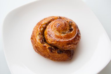 Beyaz bir plaka üzerinde pişmiş rulo