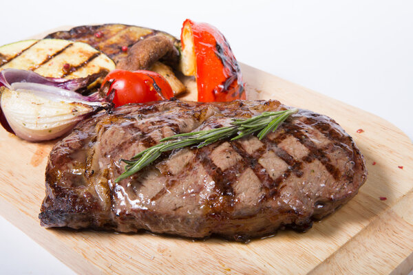 Grilled beef steak with herbs and vegetables