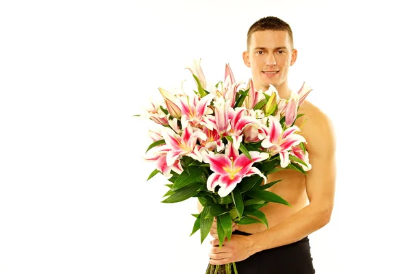 Mann hält Lilienblüten in der Hand — Stockfoto