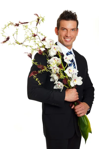 Hombre con flores de orquídeas —  Fotos de Stock