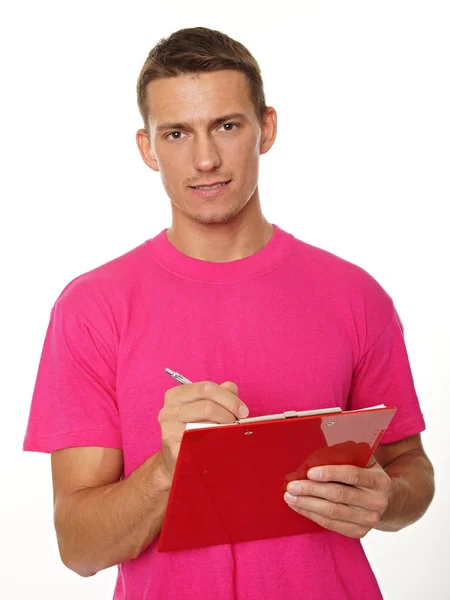 Man in pink shirt writes document — Stock Photo, Image