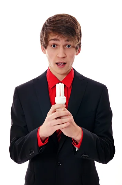 Man holds in hands a light bulb — Stock Photo, Image