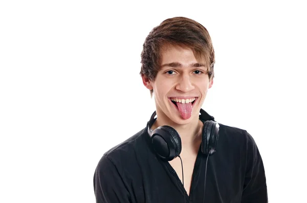 Hombre con auriculares muestra la lengua hacia fuera —  Fotos de Stock