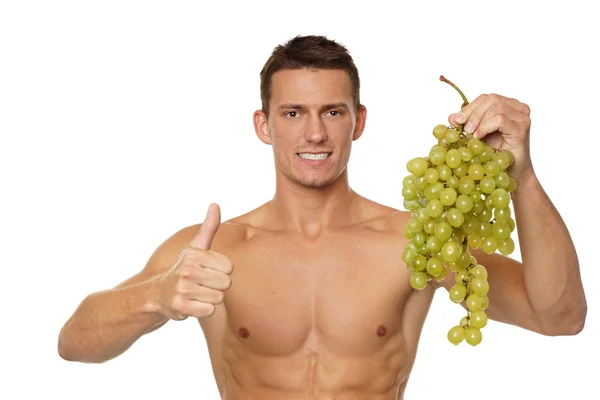 Mężczyzna trzyma w ręku winogron — Zdjęcie stockowe