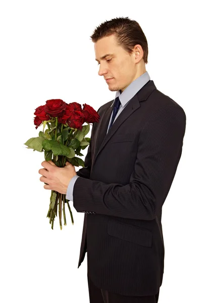 Man looking at a bouquet of roses — Stock Photo, Image