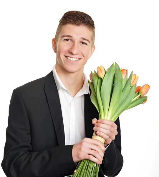 Man in suit holds bouquet of tulips — Stock Photo, Image