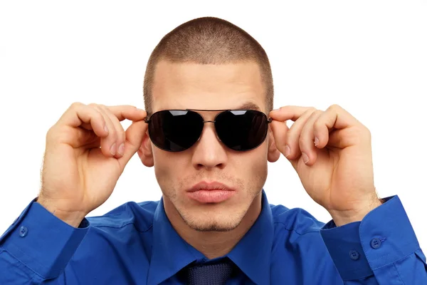 Young man holds sunglasses — Stock Photo, Image