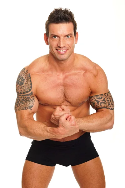 Muskularny mężczyzna pokazuje jego biceps — Zdjęcie stockowe