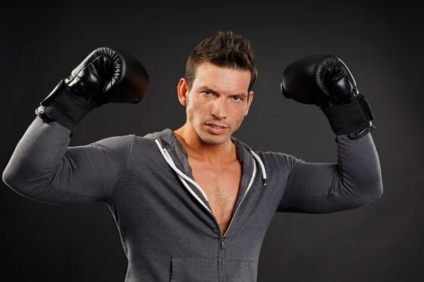 Muscular man poses with boxer gloves — Stock Photo, Image