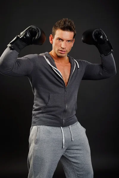 Muscular man poses with boxer gloves — Stock Photo, Image