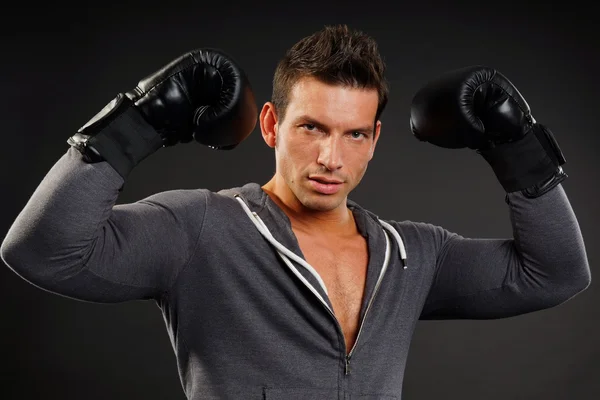 Muscular man poses with boxer gloves — Stock Photo, Image