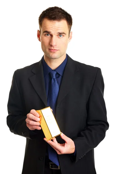 Biznesmen w stały komplet posiada gold brick — Zdjęcie stockowe