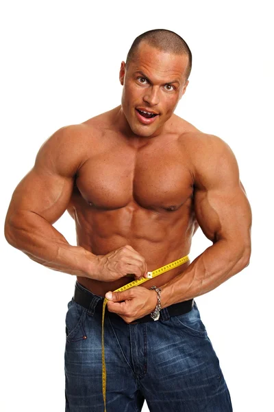 Muscular man with meter around his waist — Stock Photo, Image