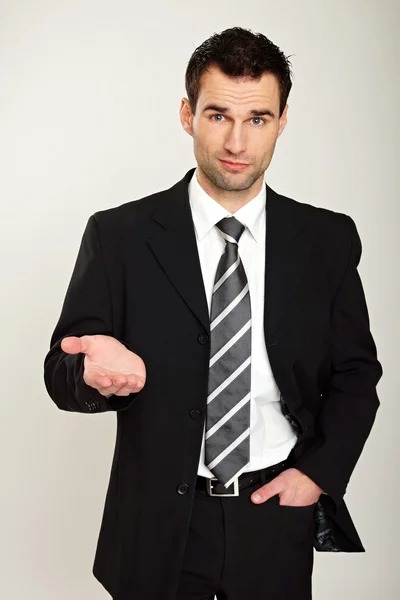 Businessman standing shows his palm — Stock Photo, Image