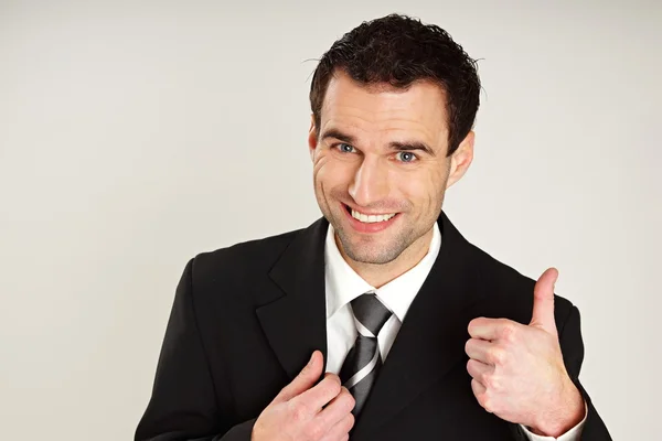 Businessman gesturing thumb up — Stock Photo, Image