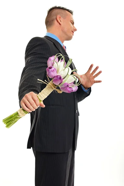 Unhappy  man holding bouquet of tulips — Stock Photo, Image