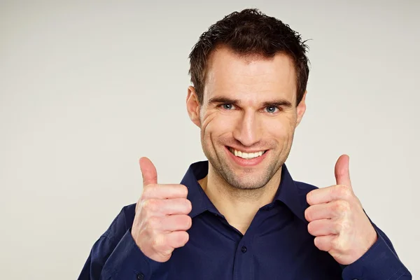 Handsome man gesturing thumbs up — Stock Photo, Image