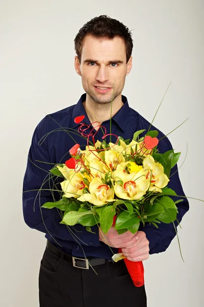 Man holds bouquet of Orchids — Stock Photo, Image