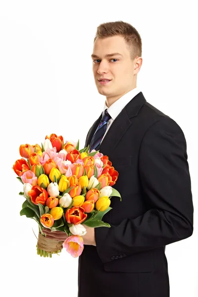 Człowiek z bukietem tulipanów — Zdjęcie stockowe