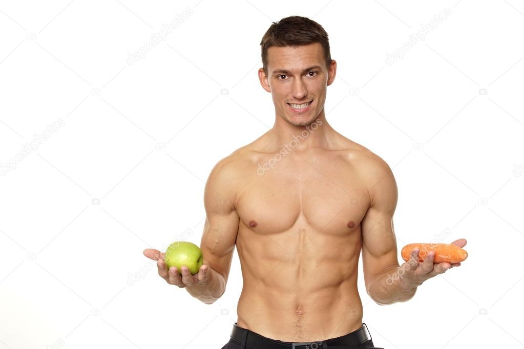 Man holds in hands apple and carrot