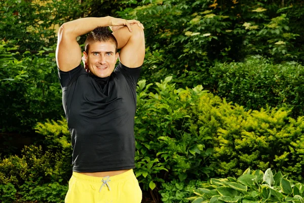 Man stretching in the garden — Stock Photo, Image